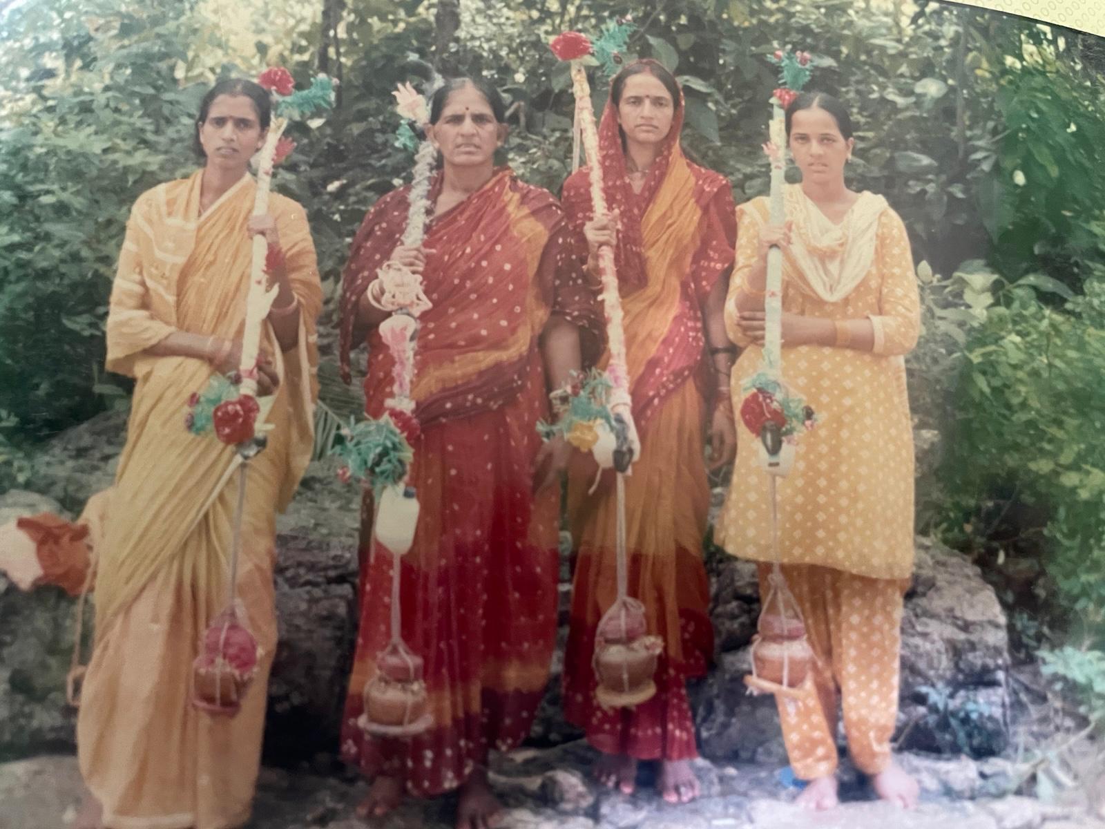 Fula Devi standing with her daughters during the Kanwar Yatra pilgrimage.