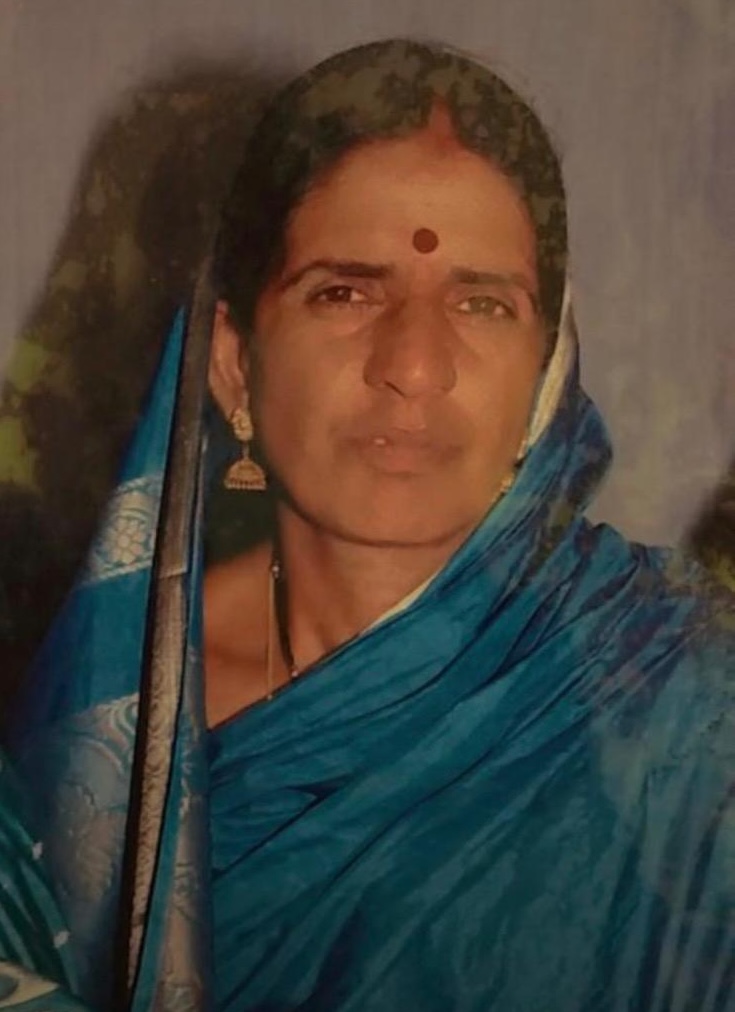 Portrait of Fula Devi wearing a blue sari and looking toward the camera.